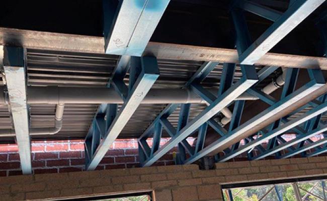 Plumbing through floor trusses