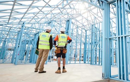 Builders standing in a truecore steel framed house